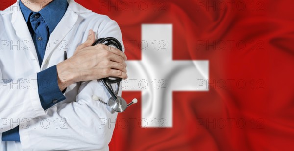 Doctor with stethoscope on Switzerland flag. Doctor holding stethoscope on Switzerland flag