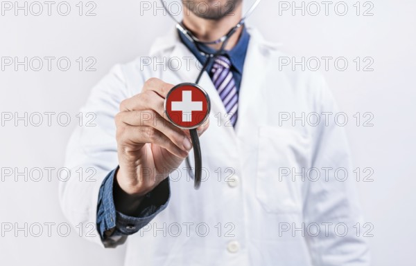 Switzerland healthcare system, doctor holding stethoscope. Switzerland health and medical insurance concept