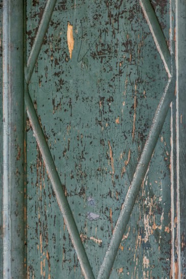 Old wooden door with peeling paint, texture, background, Germany