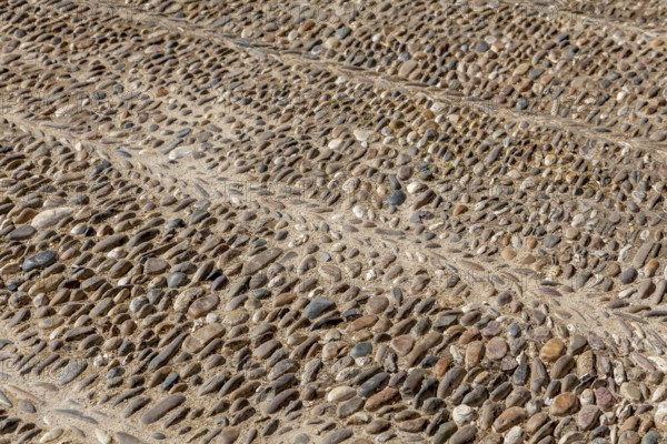 Street paving made of coloured pebbles, background, texture, Andalusia, Spain