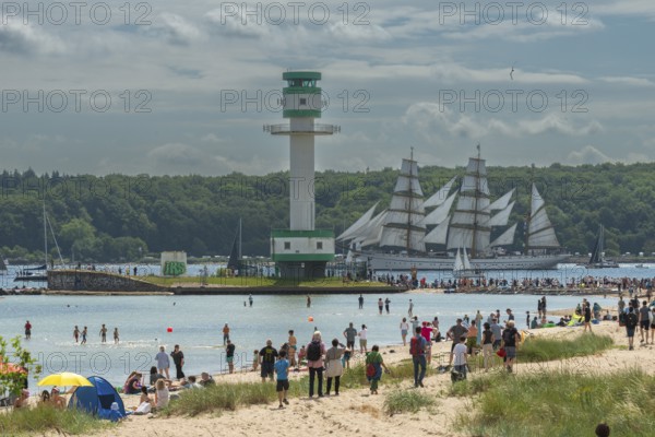 Windjammer parade 2025 on the Kiel Fjord at the end of Kiel Week, tall ships, three-master, sail training ship Gorch Fock, spectators, Falkenstein beach life, lighthouse, summer weather, sunshine, forest, Kiel, Schleswig-Holstein, Germany