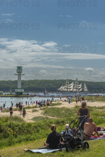 Windjammer parade 2025 on the Kiel Fjord at the end of Kiel Week, tall ships, three-master, sail training ship Gorch Fock, spectators, Falkenstein beach life, lighthouse, summer weather, sunshine, forest, Kiel, Schleswig-Holstein, Germany