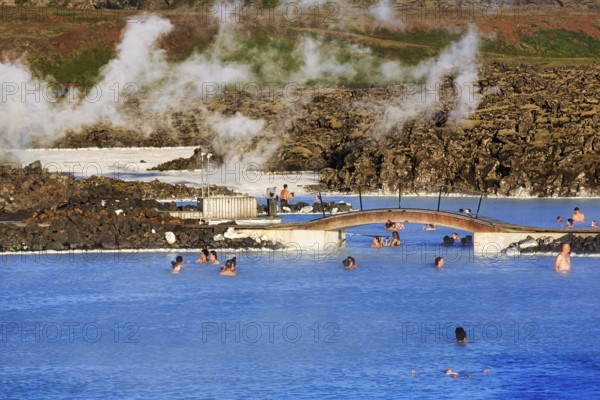 Tourists in thermal bath, outdoor pool, spa, BlÃ¡a LÃ³niÃ°, Blue Lagoon tourist attraction, hot springs, steam over volcanic landscape, Grindavik, Reykjanes Peninsula, near Reykjavik, Iceland