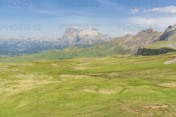 Vast green landscape with mountains and bright skies, a peaceful natural backdrop, Schlehrn hike, Alpe di Siusi, Dolomites, South Tyrol, Italy