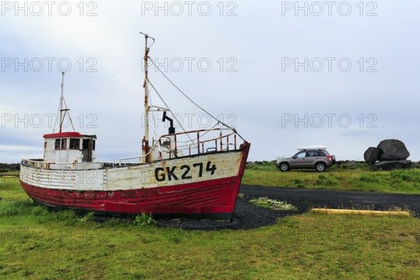 Shipwreck, fishing boat in a meadow, Gardur campsite near KeflavÃ­k, SuÃ°urnes, Sudurnes, Reykjanes Peninsula, Iceland