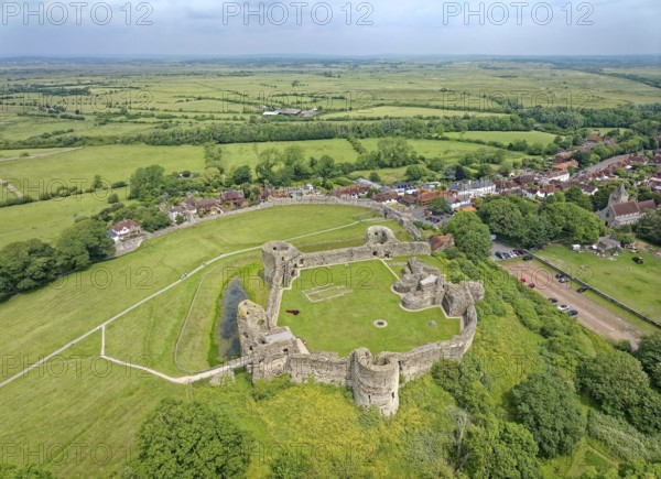 Pevensey Castle, a Norman castle. Aerial view, the village of Pevensey and the surrounding meadows and fields. Pevensey, Sussex, England, Great Britain