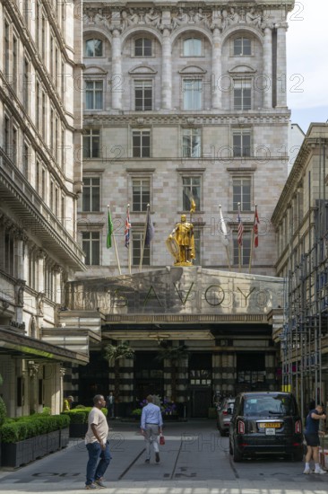 Count Peter of Savoy golden figure above entrance to The Savoy hotel, Strand, central London, England, UK