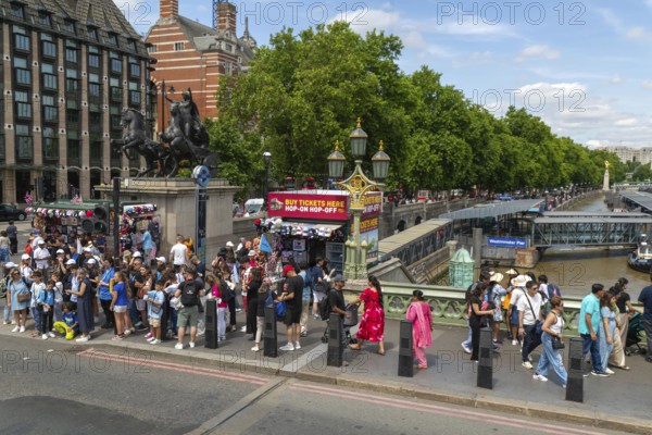 Tourists on Westminster Bridge, River Thames, Westminster, central London, England, UK