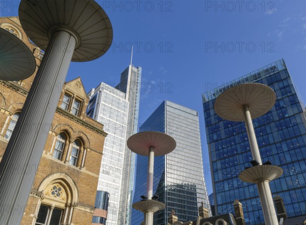 Looking up at office blocks in blue sky from forecourt of Liverpool Street station, London, England, UK