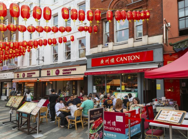 Red lanterns above Canton Chinese restaurant and bakery shop, Newport Place, Chinatown, West End, London, England, UK