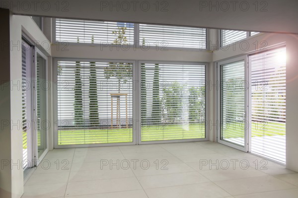 Large sliding windows with external blinds on a new building