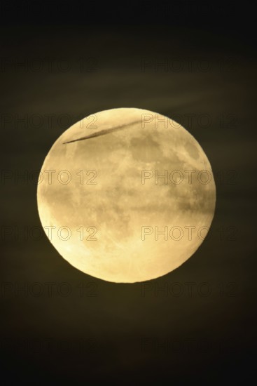 In the night sky... Full moon on an almost starry night, only a few thin clouds obscure the moon, while a distant aeroplane flies past directly in front of the moon, full moon, super moon, strawberry moon, local nature, Meerbusch, DÃ¼sseldorf, Rhineland, Lower Rhine, North Rhine-Westphalia, Germany, Western Europe