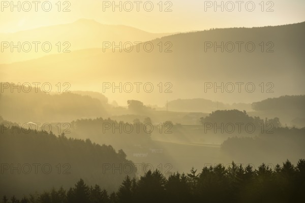 Landscape with forest, meadows and mountains around the town of Bad Kötzting, with a part of the Kaitersberg in the background on the right. In the morning at sunrise. District of Cham, Upper Palatinate, Bavarian Forest, Bavaria, Germany