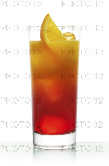 Campari orange in a long drink glass on ice with orange slices as garnish against a white background, studio shot