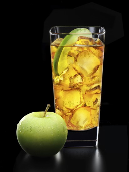 Cocktail in a long drink glass on ice with half an apple slice and apple as garnish in front of a black background, studio shot