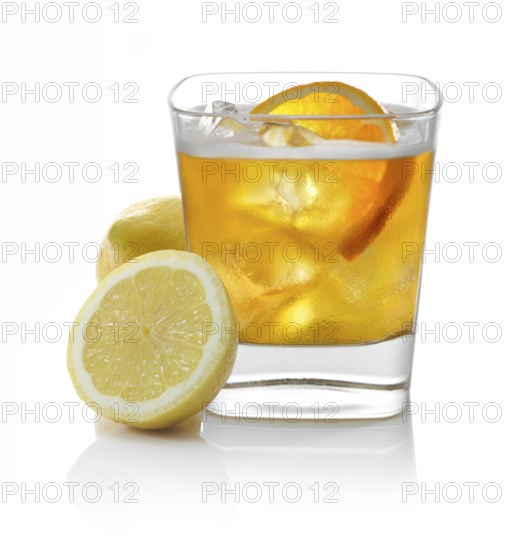 Cocktail in a tumbler on ice with half a slice of orange and lemons as garnish against a white background, studio shot