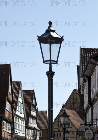 Street with half-timbered houses and historic street lamp in the old town centre, Celle, Lower Saxony, Germany