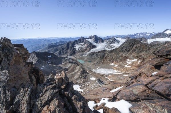 View of mountain basin with blue glacier lakes, behind summit Becher with Becherhaus, glacier Ãœbeltalferner and summit Königshofspitz, descent from summit Wilder Freiger to Roter Grat, Stubai Alps, South Tyrol, Italy