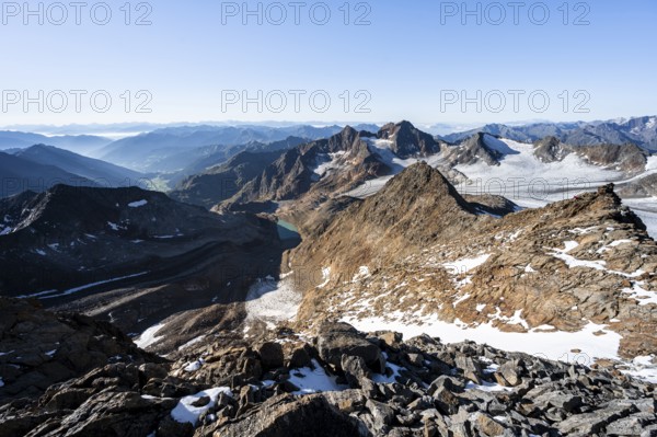 Rocky ridge on the Wilder Freiger mountain peak, behind Signal summit and Becher summit with Becherhaus, picturesque high mountain landscape, view of Ãœbeltalferner glacier and rocky mountain peaks Königshofspitz and Sonklarspitze, Stubai Alps, South Tyrol, Italy