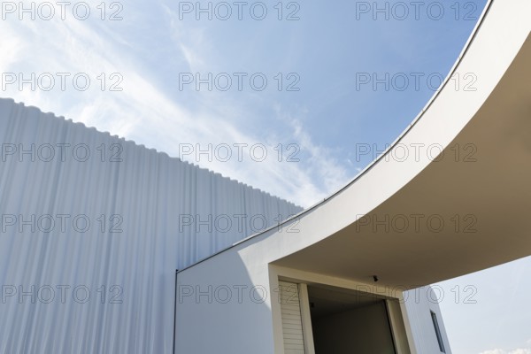 Modern white faÃ§ade made of corrugated acrylic glass, Plexiglas, SANAA production hall, architect Kazuyo Sejima and Ryue Nishizawa, covered entrance, Vitra Campus, Vitra Design Museum, Weil am Rhein, Baden-WÃ¼rttemberg, Germany