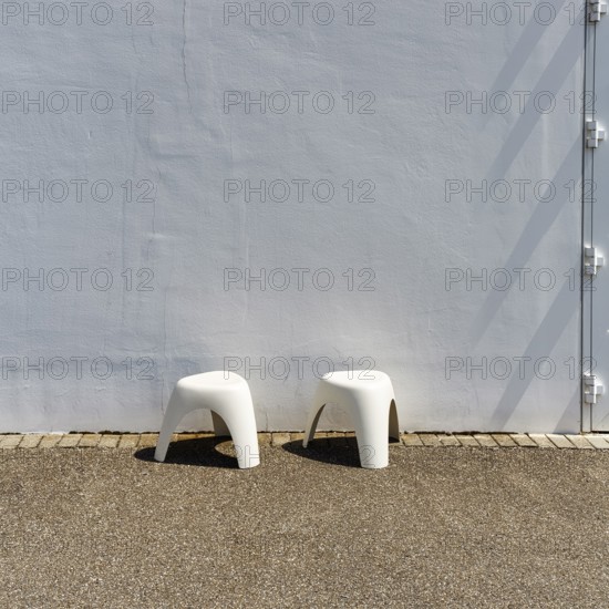 Two white plastic stools in front of a white wall, Elephant Stool, design Sori Yanagi, stackable, Vitra Campus, Vitra Design Museum, Weil am Rhein, Baden-WÃ¼rttemberg, Germany