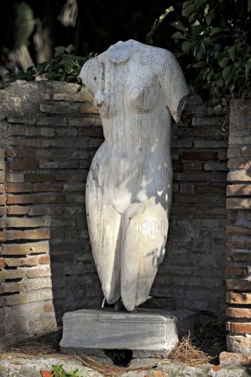 Naked woman, torso of a female statue, marble carving, remains, ruins, ancient port city of Rome, excavation site Archaeological Park Ostia Antica, metropolitan city of Rome, Lazio, Italy