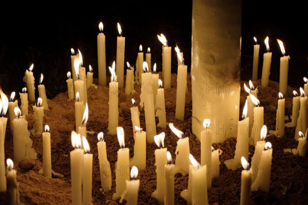 Candles placed by the faithful as offerings during their prayers