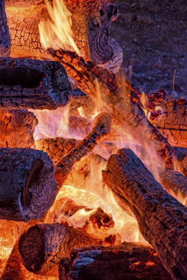 Logs of burning wood burning in a bonfire during a religious festival in honor of Saint John in Brazil, Minas Gerais, Brazil