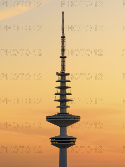 Television tower Heinrich-Hertz-Turm (Telemichel) in front of a yellow sky at sunset, Hamburg, Germany