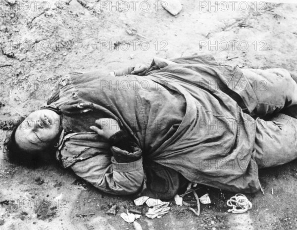 Chinese woman in Brenan Road, Shanghai. Shot for looting. The Second Sino-Japanese War began on 7 July 1937 and lasted until 9 September 1945. It was a full-scale invasion of China by the Japanese
