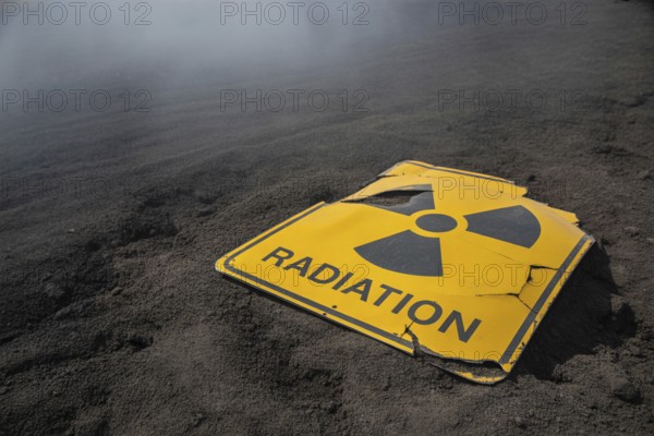 Damaged radiation warning sign in scorched earth. Symbol of catastrophe and nuclear ruin. Generative ai, AI generated