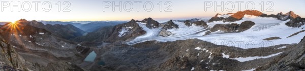 Panorama at sunrise with sun star, high mountain landscape, view of blue glacial lakes, mountain peaks Königshofspitz and Hofmannspitze with glacier of the Ãœbeltalferner, Stubai Alps, South Tyrol, Italy