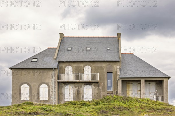 Old house with closed window shutters on a hill at a coastal area, Camaret-sur-Mer, Crozon Peninsula, Bretagne, France