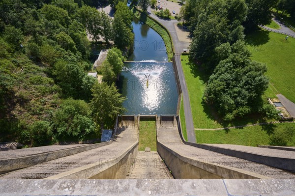 View from a high point of a dam and a river surrounded by green trees, Oleftalsperre, Hellenthal, Eifel, North Rhine-Westphalia, Germany