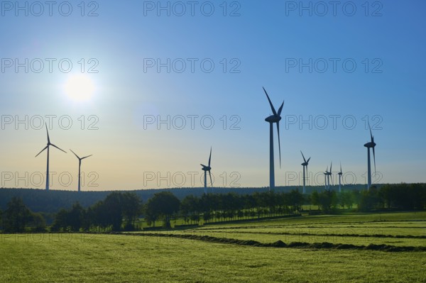 Wind turbines adorn a landscape with sunny skies and green fields, summer, Rohren, Monschau, Eifel, North Rhine-Westphalia, Germany