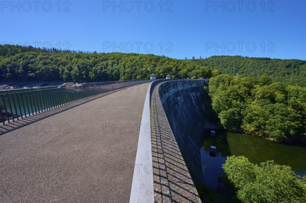 Long dam with neighbouring river and surrounding forest, clear sky, summer, Urft dam wall, Obersee, Urftsee, Schleiden, Eifel National Park, Eifel, North Rhine-Westphalia, Germany