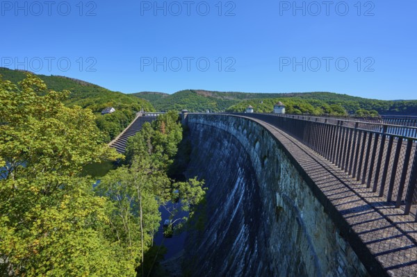 High view of a large dam with neighbouring forest and clear sky, summer, Urft dam wall, Obersee, Urftsee, Schleiden, Eifel National Park, Eifel, North Rhine-Westphalia, Germany