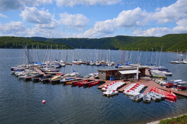 Boats gather at a large jetty, under a cloudy sky, summer, Rursee, Rurtalsperre, Heimbach, Simmerath, Eifel National Park, North Rhine-Westphalia, Germany