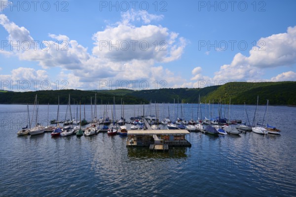 Sailing boats at a jetty, with partly cloudy sky, summer, Rursee, Rurtalsperre, Heimbach, Simmerath, Eifel National Park, North Rhine-Westphalia, Germany