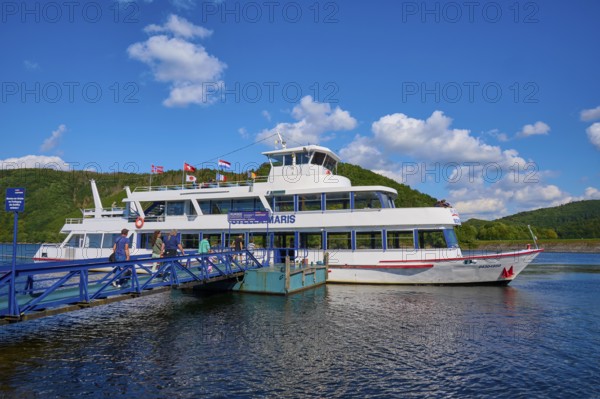 Passenger ship lying at a jetty on a lake with a deep blue sky and fleecy clouds, summer, Rursee, Rurberg, Simmerath, Eifel National Park, North Rhine-Westphalia, Germany