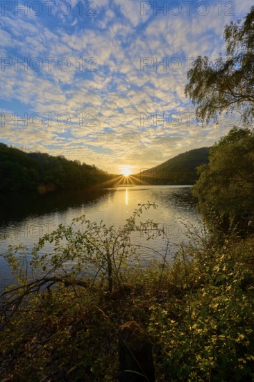 Golden sunbeams spread across the lake, dramatically surrounded by clouds, summer, Rursee, Obersee, Simmerath, Eifel National Park, North Rhine-Westphalia, Germany