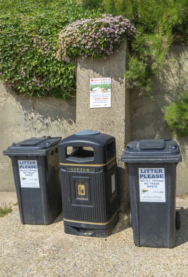 Litter rubbish waste bins and notice about littering fines, Southwold, Suffolk, England, UK