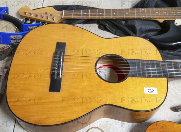 Acoustic guitar viewed from above on display at auction, UK