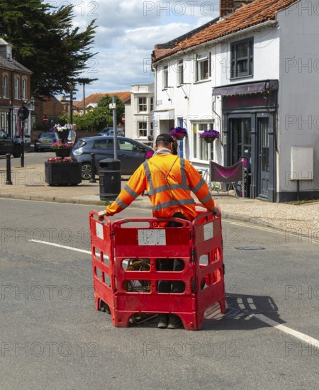 British Telecom technicians working on fibre optic Broadband in street, Southwold, Suffolk, England, UK