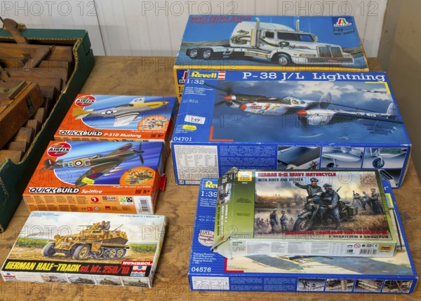 Boxes of Revell and Airfix military vehicles and planes scale models on display at auction, UK