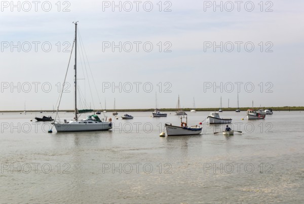 Boats at moorings on River Ore, Orford, Suffolk, England, UK