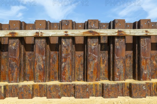 Old rusty steel sheet piling sea wall coastal defence, River Deben, Bawdsey, Suffolk, England, UK