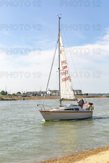 Sailing boat yacht at mouth of River Deben estuary, Bawdsey Quay, Suffolk, England, UK