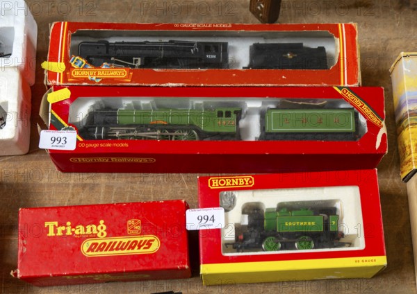 Model railway toy train set items on display for sale at auction room, UK