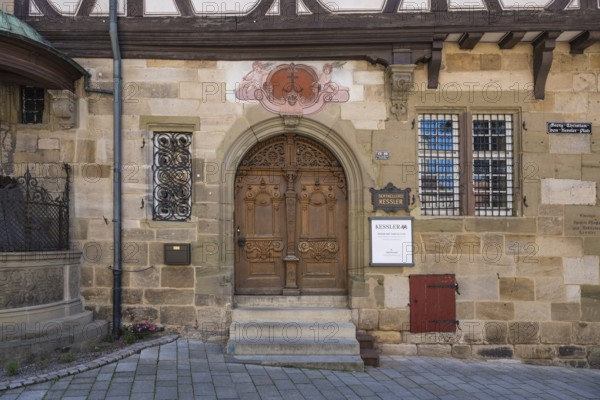 Detailed view of a historic half-timbered house with an ornate, double-leaf wooden door, Kessler sparkling wine cellars, former Speyrer Pfleghof in Esslingen's old town centre, Esslingen am Neckar, Esslingen district, Baden-WÃ¼rttemberg, Germany